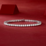 Silver bracelet with clear stones on a red background