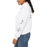 White hoodie with Max Fuega on left sleeve worn by a person on a white background