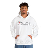 Person wearing a white hoodie with 'Love Me Like A Martian' text and heart design.