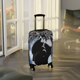 Luggage with a whale design in a room with a window and chair.