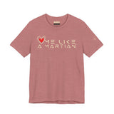 Pink t-shirt with 'Love Me Like a Martian' text and heart graphic on a white background
