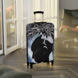 Luggage with a black cat design on a wooden floor