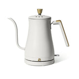 White electric kettle with gold accents on a white background