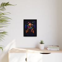 Framed artwork on a wall above a wooden desk with a plant and books.