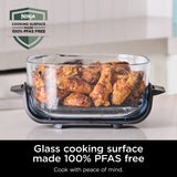 Glass cooking surface with roasted chicken wings on a kitchen counter, featuring the Ninja brand.